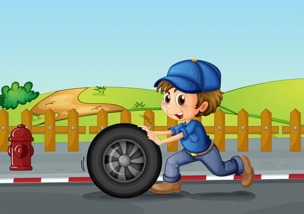 A boy wearing a hat pushing a wheel along the road — Stock Vector