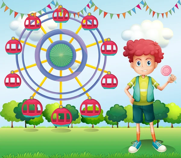 A boy holding a lollipop beside a ferris wheel — Stock Vector