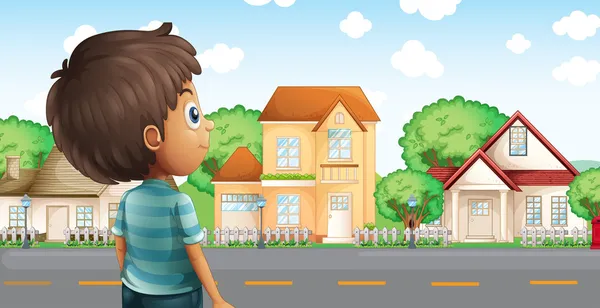 A young boy standing across the village — Stock Vector