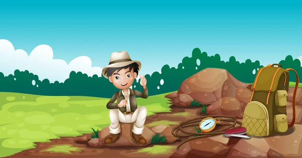 Um rapaz a usar um chapéu sentado numa pedra — Vetor de Stock