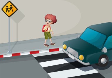 A young boy with a backpack standing near the pedestrian