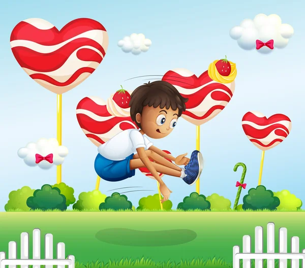Um menino pulando no campo com pirulitos gigantes — Vetor de Stock