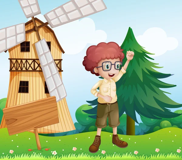Un niño feliz cerca del letrero de madera y el molino de viento — Archivo Imágenes Vectoriales
