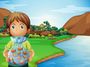 A young boy at the riverbank holding a plastic full of fishes clipart