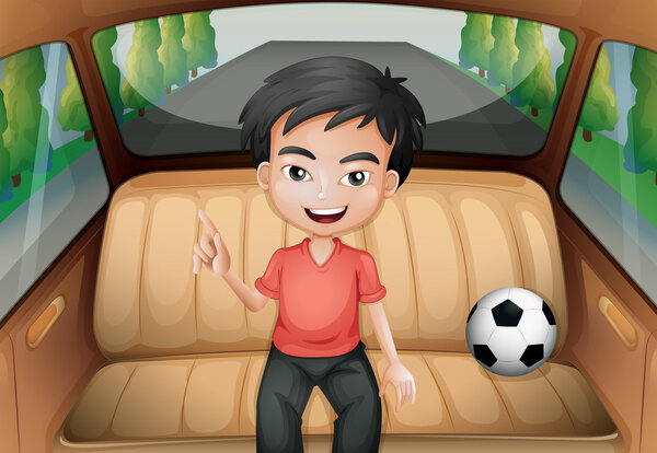 Мальчик в машине с футбольным мячом
