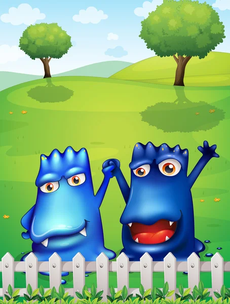 木栅栏附近的两个蓝色怪物 — 图库矢量图片