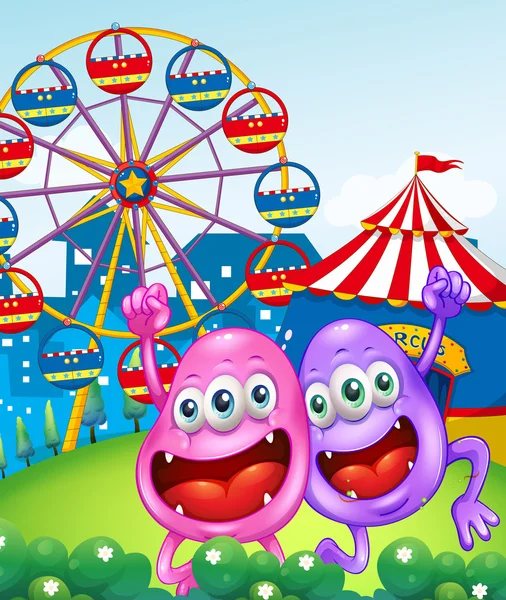 Two happy monsters near the carnival — Stock Vector