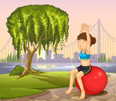 bir kızın yanında dev ağaç zıplayan topu ile egzersiz