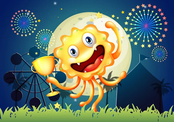Un monstre heureux au carnaval tenant un trophée — Image vectorielle