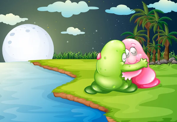 A green monster comforting the pink monster at the riverbank — Stock Vector