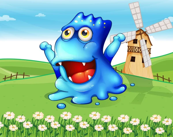 A happy blue monster at the hiltop with a windmill — Stock Vector