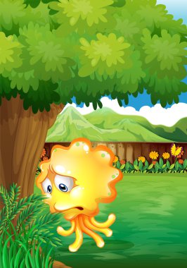 ağacın altında bir üzücü sarı monster