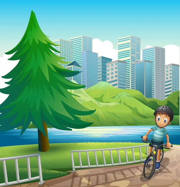 Un niño en bicicleta a través de los edificios altos cerca del río — Vector de stock