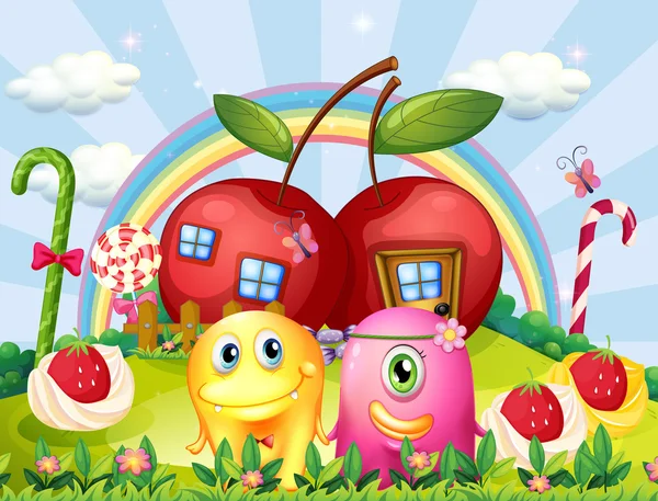 Coppia mostri in cima alla collina con un arcobaleno e case di mele — Vettoriale Stock