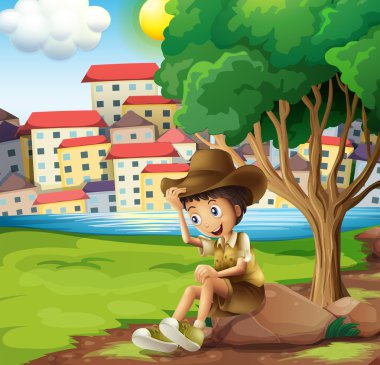 yüksek bina genelinde kaya üzerinde oturan bir genç explorer