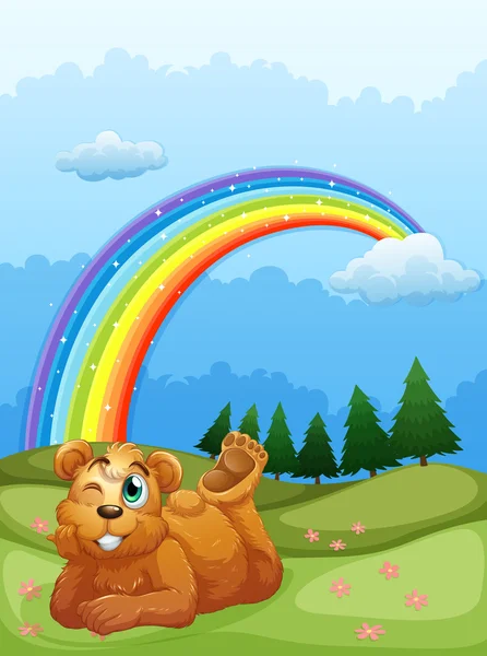 Un oso en la colina con un arco iris en el cielo — Archivo Imágenes Vectoriales