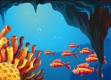 A school of fishes going to the coral reefs inside the cave clipart