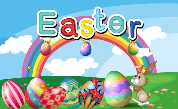 Una collina con uova di Pasqua, un arcobaleno e un coniglio — Vettoriale Stock