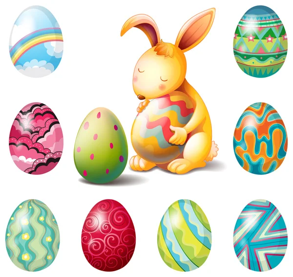 Un grupo de huevos de Pascua y un conejito dulce — Vector de stock