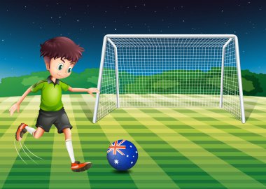 A boy kicking the soccer ball at the field with the flag of Aust vector A boy kicking the soccer ball at the field with the flag of Aust vector