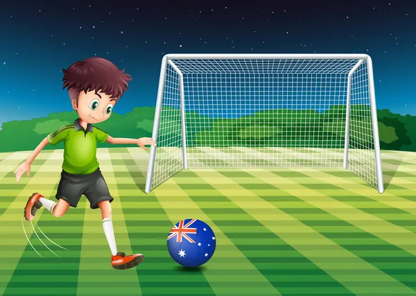 A boy kicking the soccer ball at the field with the flag of Aust — Stock Vector