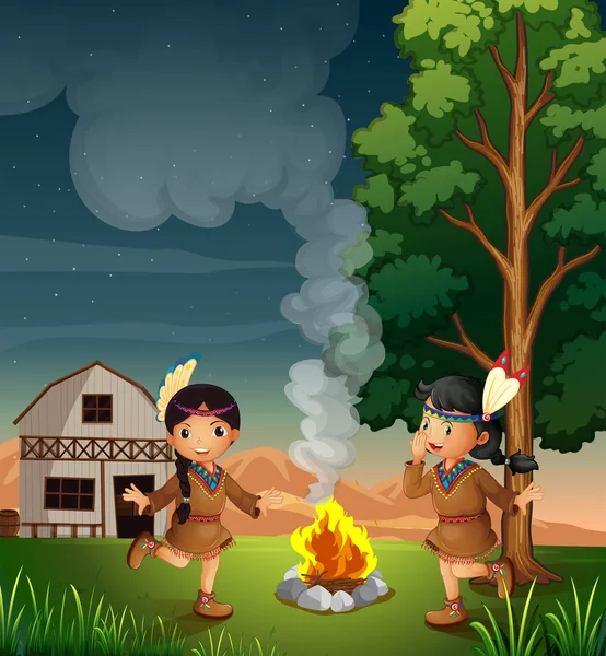Two little Indians with a campfire — Stock Vector