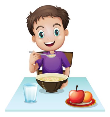 A boy eating his breakfast at the table
