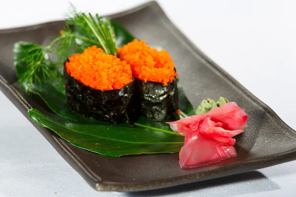 Two nigiridzusi on bamboo leaf whith wasabi on the plate — Stock Photo, Image