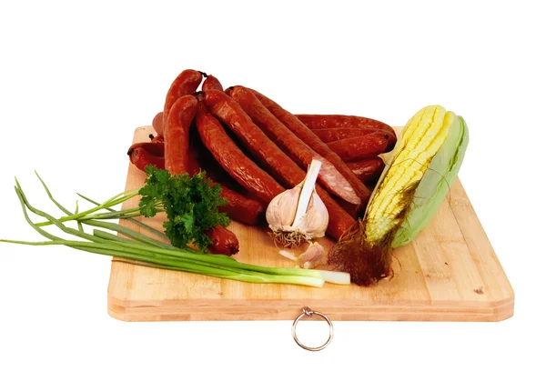 Long and thin smoked sausages on a wooden board — Stock Photo, Image