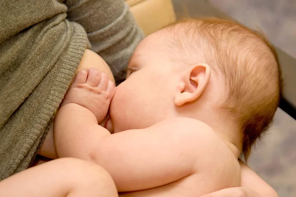 Newborn baby is breast feeding — Stock Photo, Image