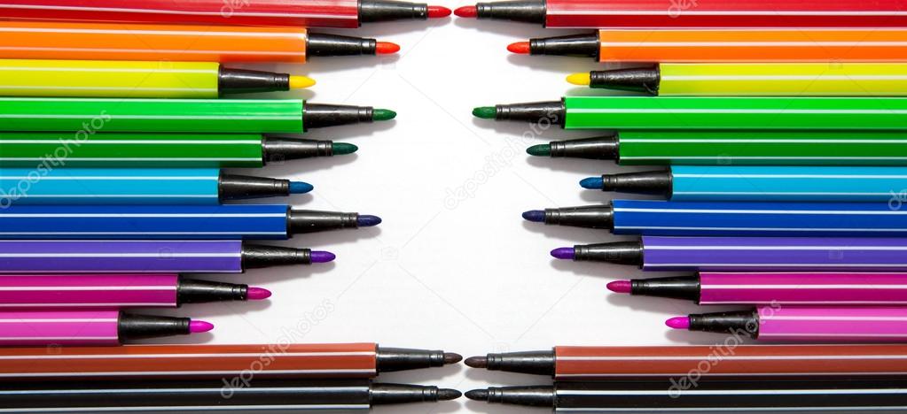 The frame in the form of Christmas tree made of multicolored striped markers. Place for your text, symbol or logo