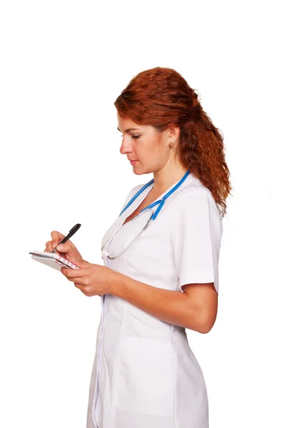 Doctor escuchando atentamente al paciente y escribiendo algo en un cuaderno — Foto de Stock