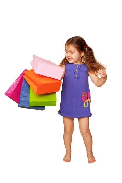 Kleine mooie brunette meisje met shopping tassen — Stockfoto