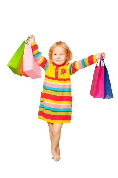 Fashion little blond girl with shopping bags — Stock Photo, Image