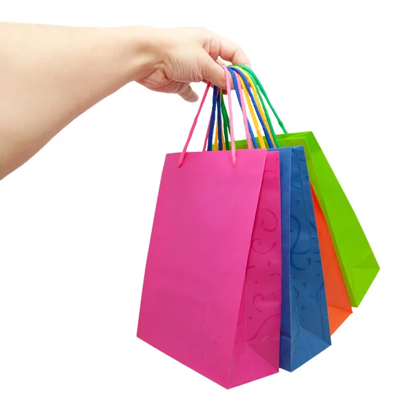 Hand att ge färgglada papper shoppingkassar — Stockfoto