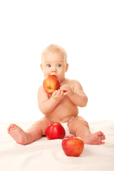 Laughing baby with big red apples — Stock Photo, Image
