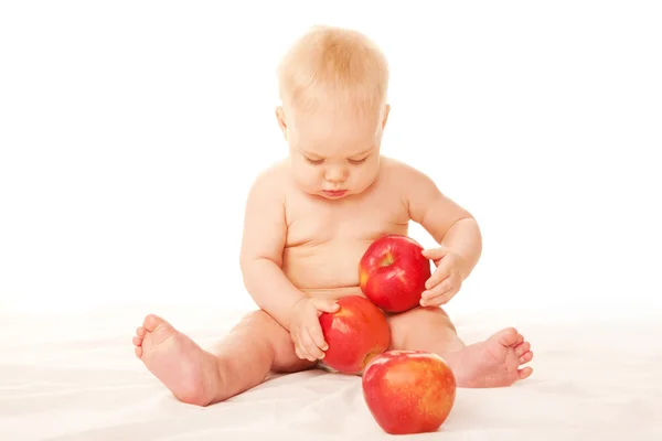 Laughing baby with big red apples — Stock Photo, Image