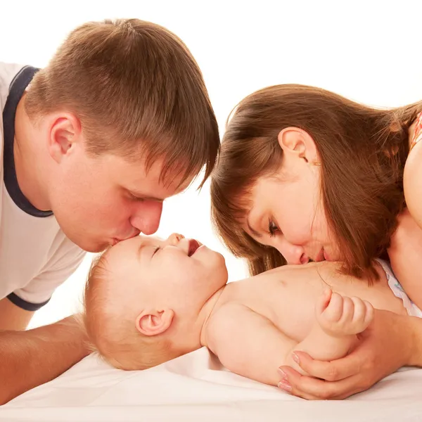 Parents kissing baby. — Stock Photo, Image