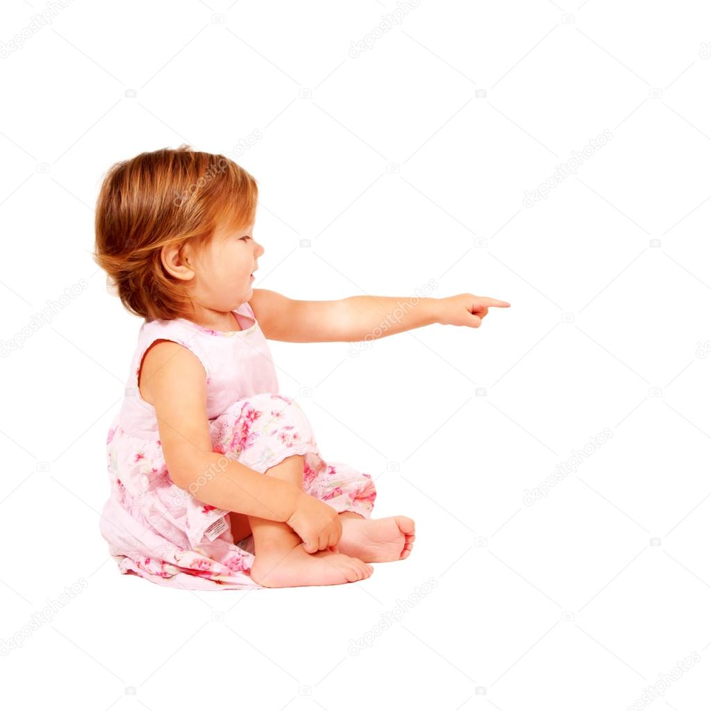 Baby pointing at something or clicking on something. A side view. Ready for your text or logo. Isolated on white background