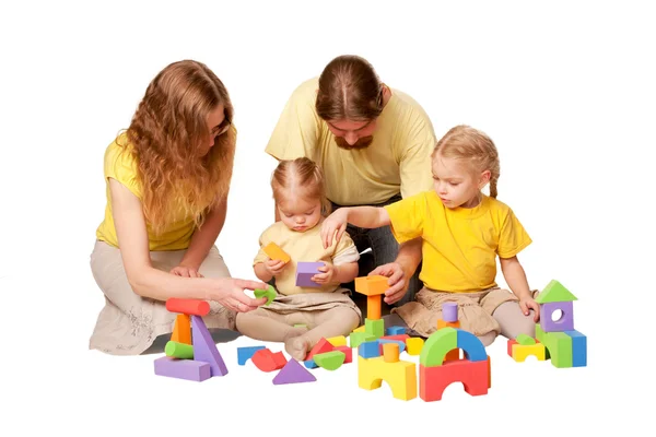 Happy family building from toy blocks — Stock Photo, Image