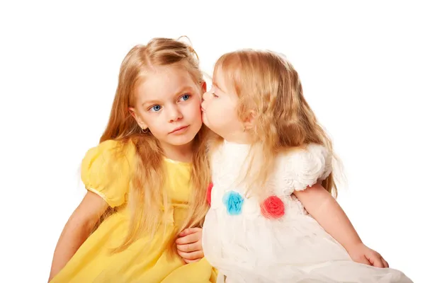 Younger sister kissing elder sister. — Stock Photo, Image