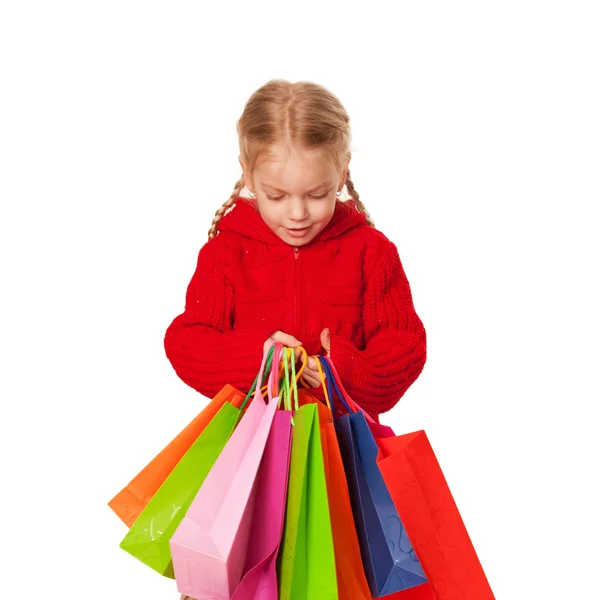 Shopping petite fille tenant un grand nombre de sacs . — Photo