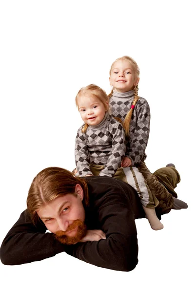 Father and two children sitting on back of their father. — Stock Photo, Image