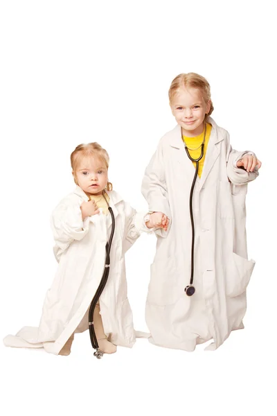 Two sisters playing as doctors. — Stock Photo, Image