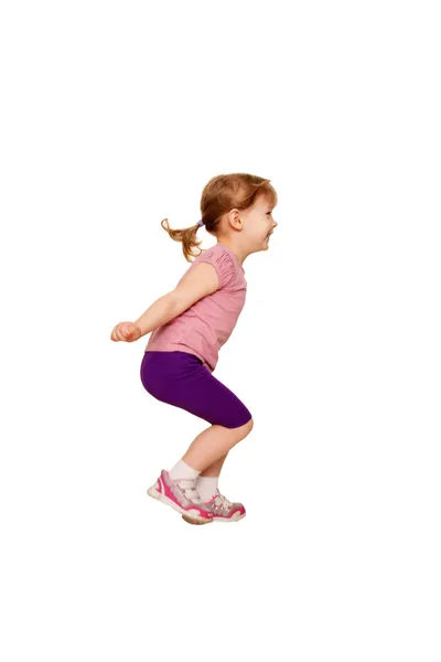 Little girl jumping. A side view. — Stock Photo, Image