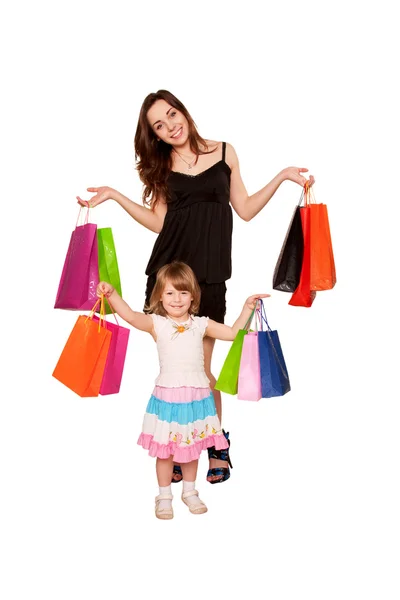 Two sisters, a teenager and a little girl holding up shopping b — Stock Photo, Image