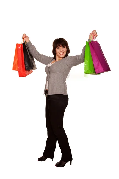 Happy middle-aged woman with shopping bag. Isolated on white — Stock Photo, Image