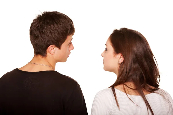Teens couple looking at something and talking. Rear view — Stock Photo, Image