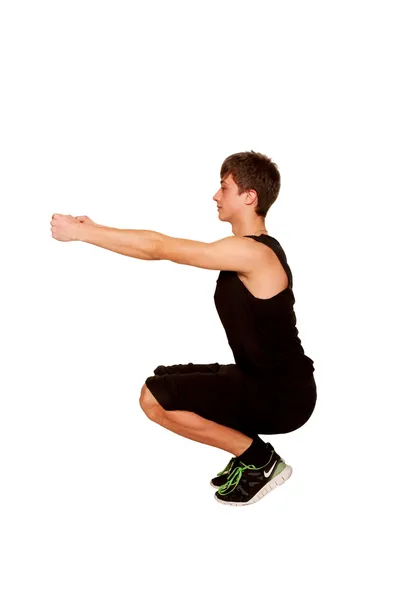 Adolescente menino jogando esportes, agachamento, treino de fitness . — Fotografia de Stock