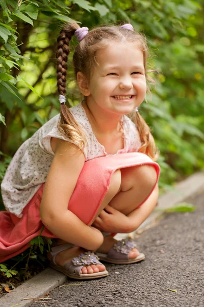 Little funny girl with pigtails outdoors — Stock Photo, Image